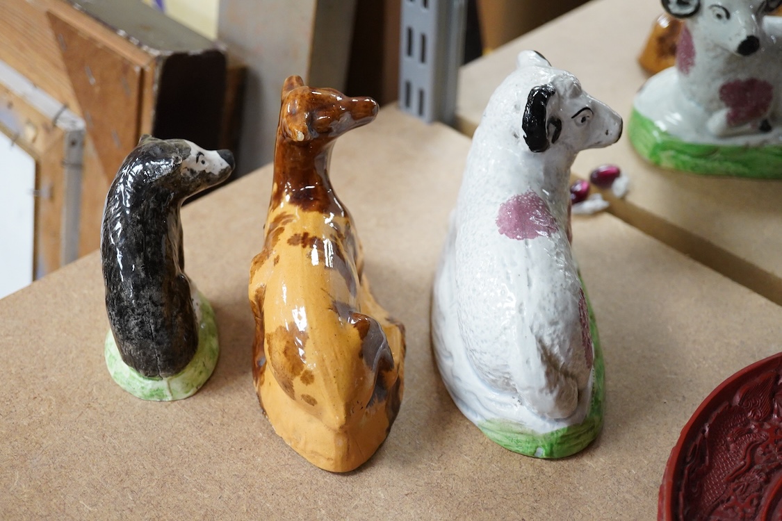 A Staffordshire Pearlware figure of a recumbent ewe, a Staffordshire glazed terracotta figure of a recumbent deer and a Staffordshire pearlware model of a badger?, largest 14cm wide